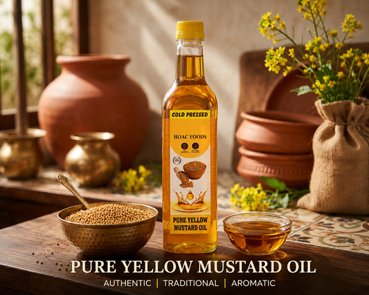 Pure yellow mustard oil being poured from a glass bottle into a bowl, golden in colour